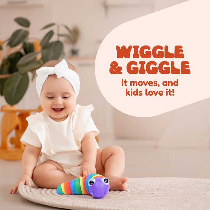 A baby wearing a white ruffled outfit and a white bow headband sits on a rug indoors, smiling while playing with a colorful striped caterpillar toy. Large text on the right reads 'WIGGLE & GIGGLE It moves, and kids love it!'.