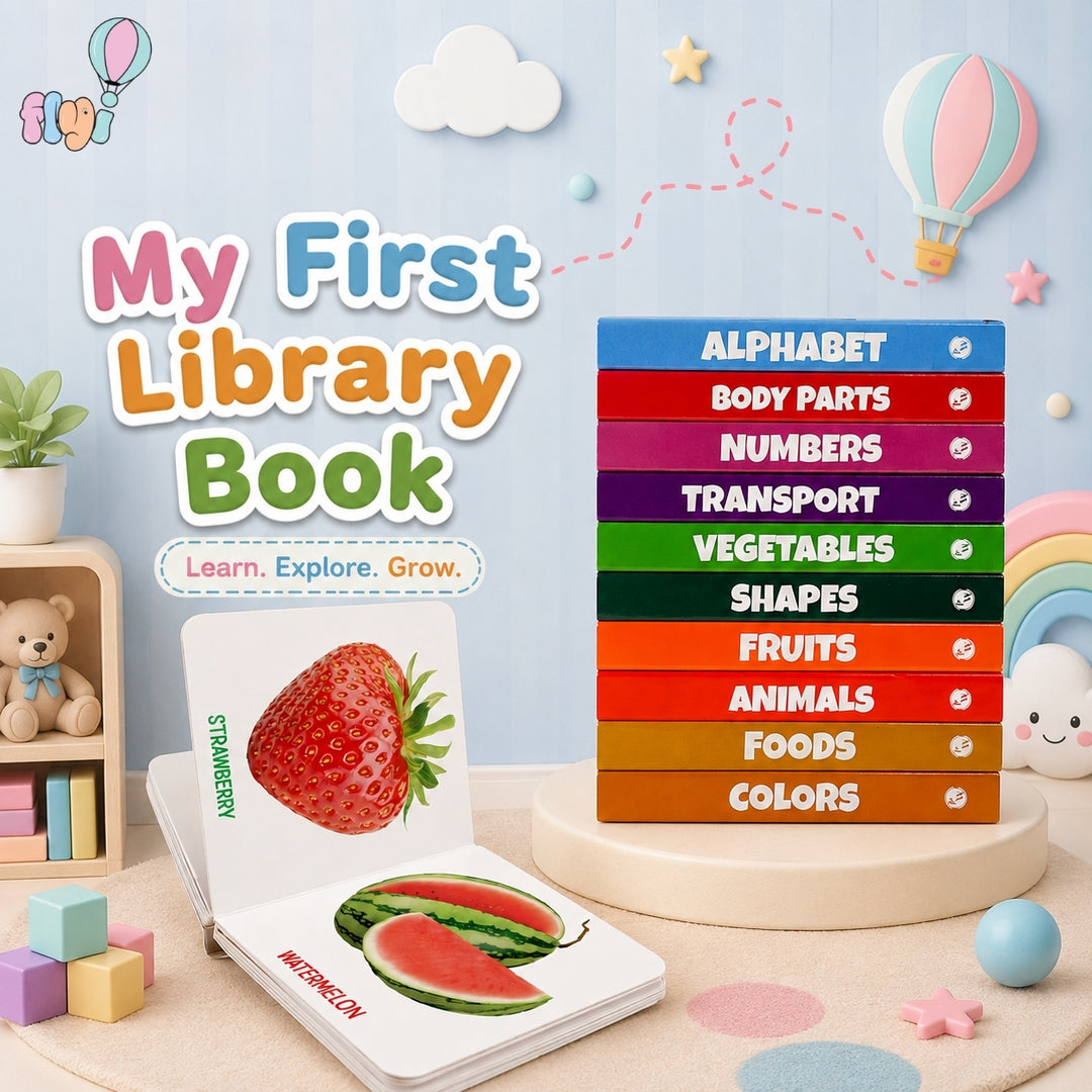 My First Library Book set displayed in a styled children's room scene. The set includes a colorful stack of books on a round pedestal and an open book showing illustrated pages about strawberries and watermelons.