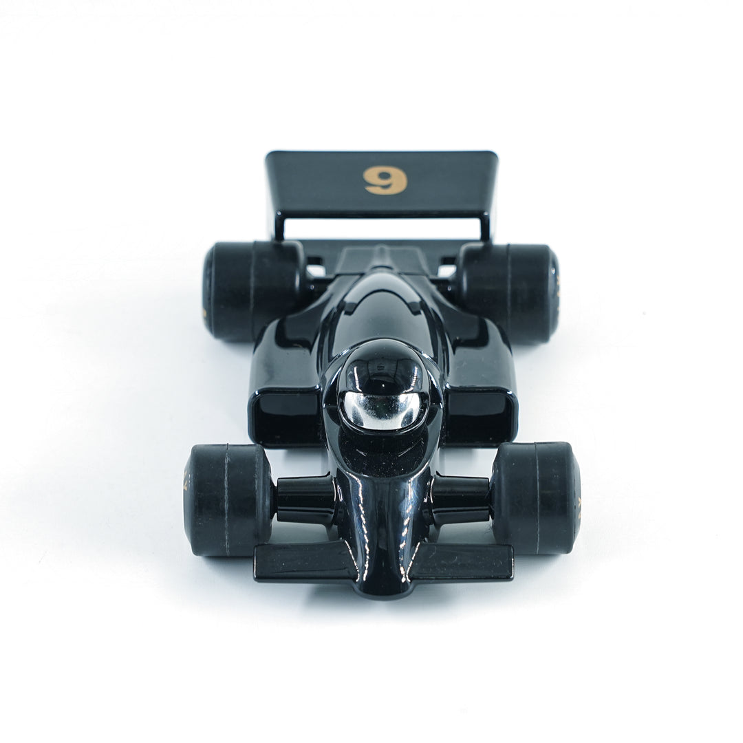 Black toy Formula 1 car with number 9 on a white background