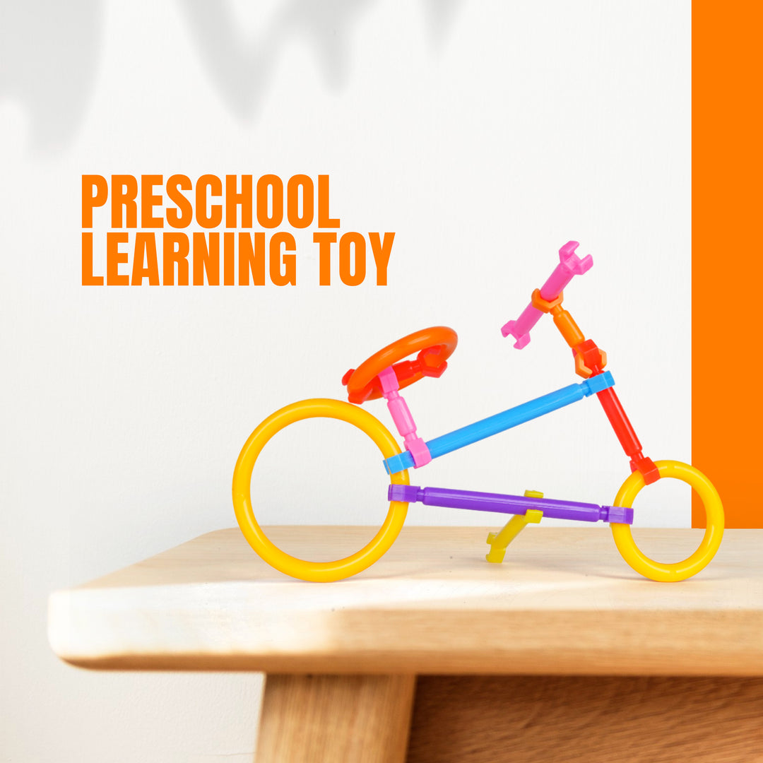 Colorful FLYI toy bicycle on a wooden surface with 'Preschool Learning Toy' text.