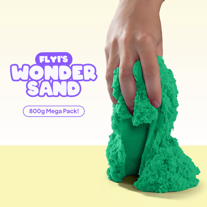 Green FLYI'S WONDER SAND being held with a hand on a light yellow background